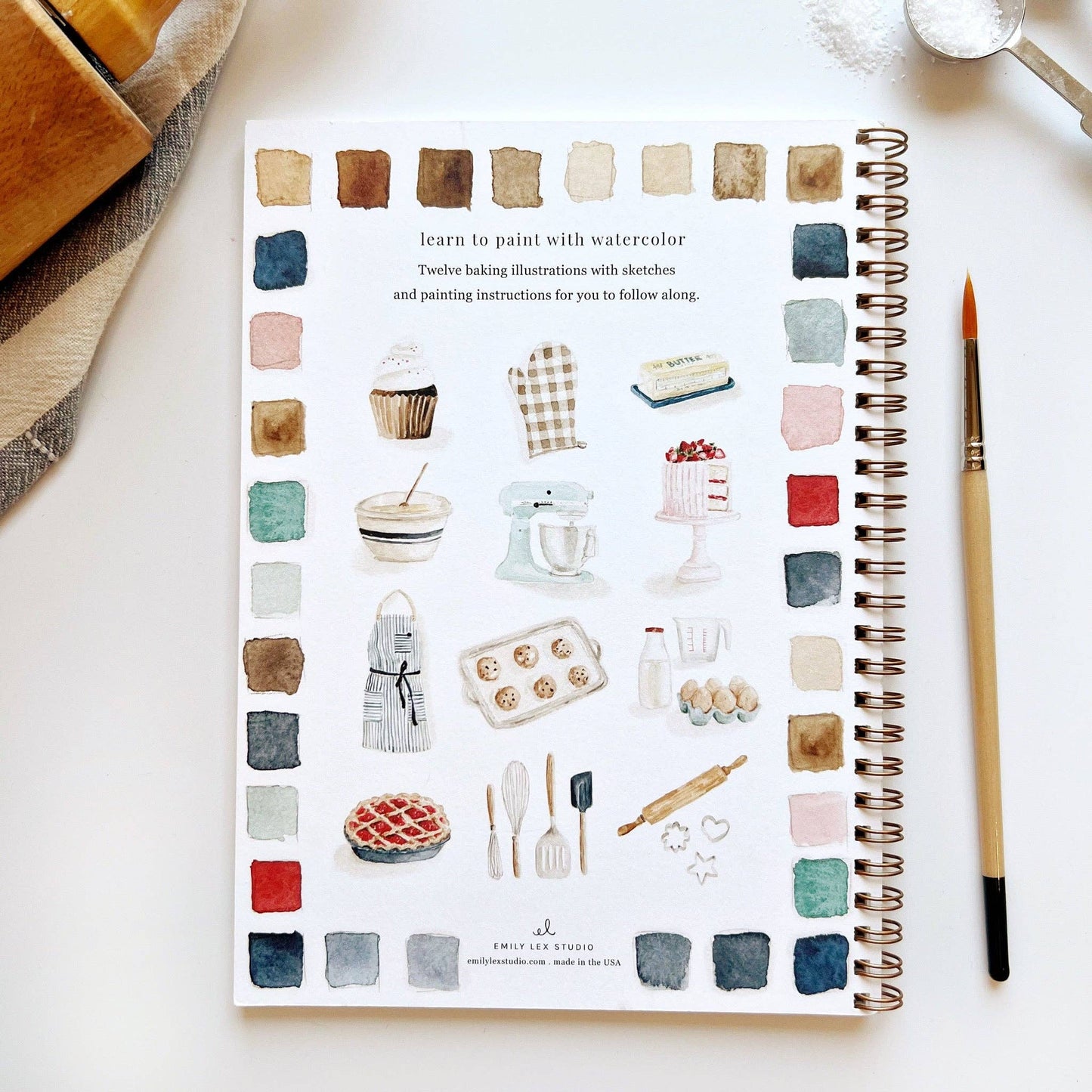 Illustrated baking book with watercolor illustrations on a white surface