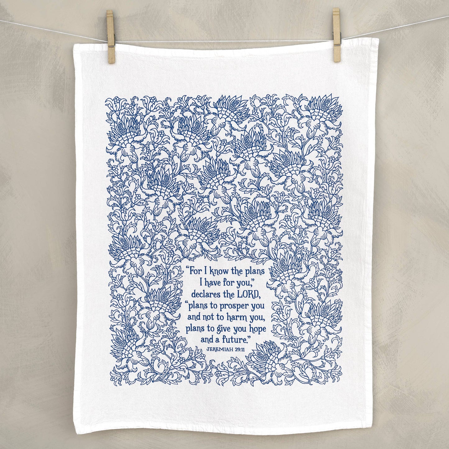 Eco-friendly flour sack towel with faith-based message displayed next to kitchen decor