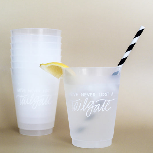 white We've Never Lost a Tailgate' cup, Tailgate party cup, Football party cup