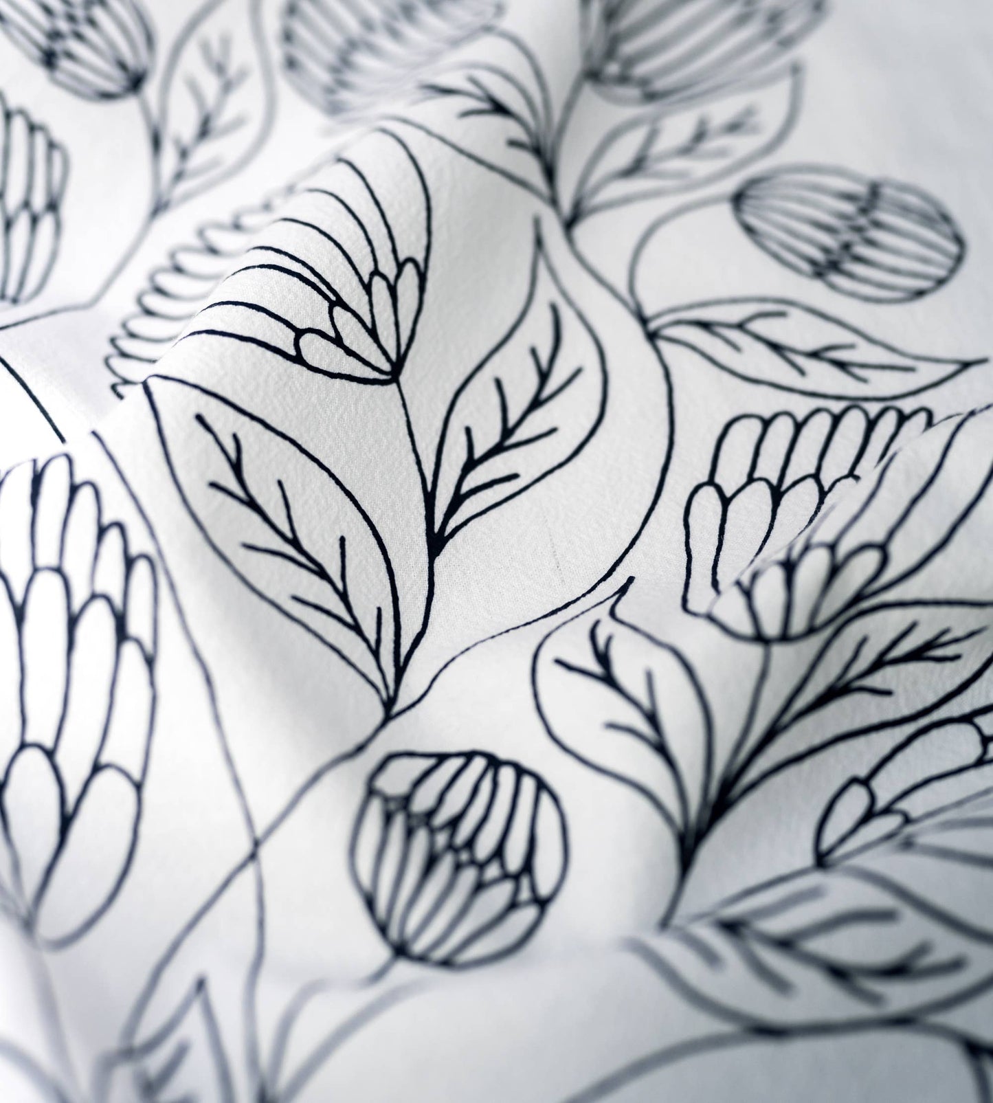 Close-up of florals and hand-lettered Bible verse printed on white cotton fabric