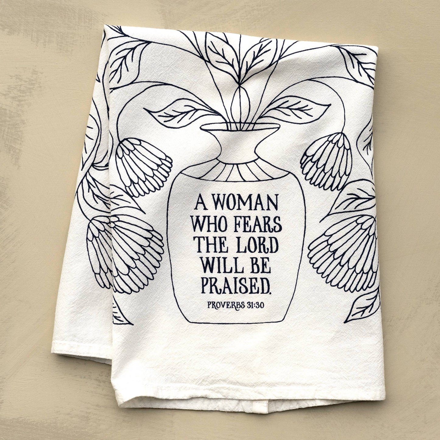 Close-up of hand-lettered Bible verse printed on white cotton fabric