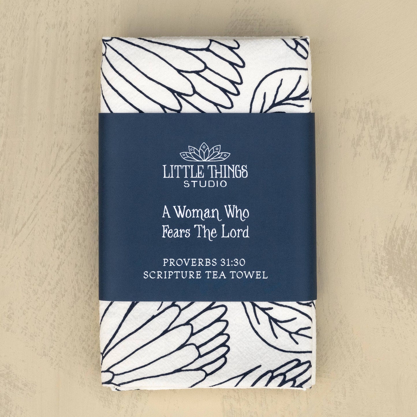 Folded tea towel with belly band packaging featuring Proverbs 31 text