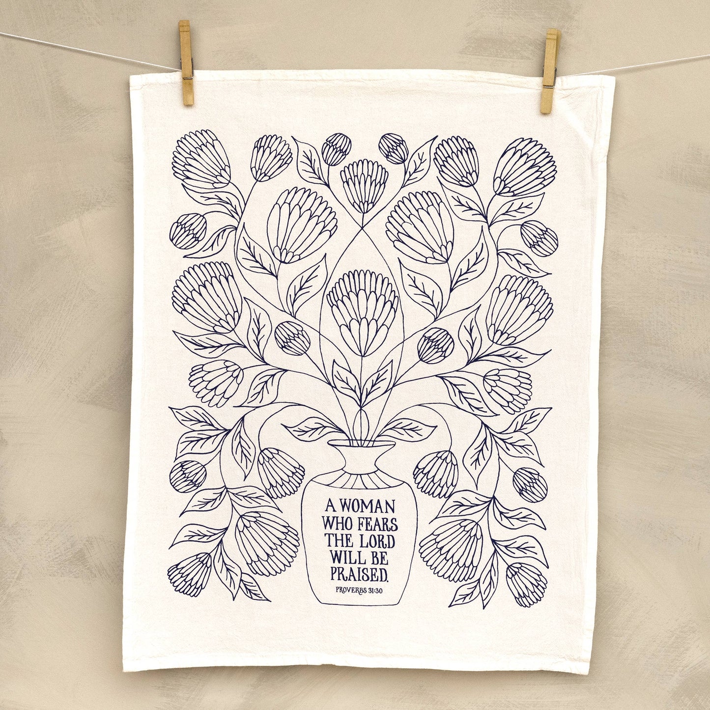 Close-up of hand-lettered Bible verse printed on white cotton fabric