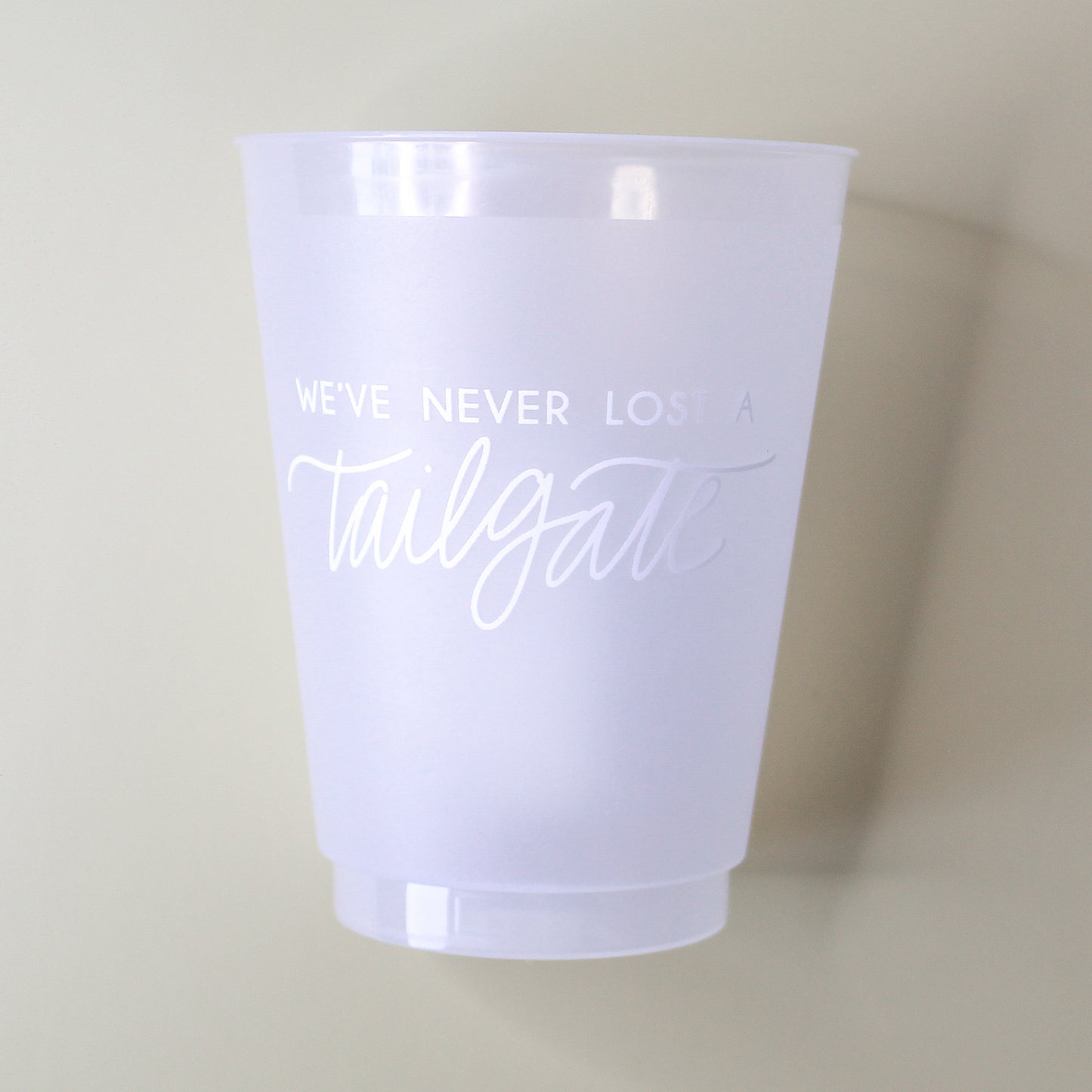white We've Never Lost a Tailgate' cup, Tailgate party cup, Football party cup