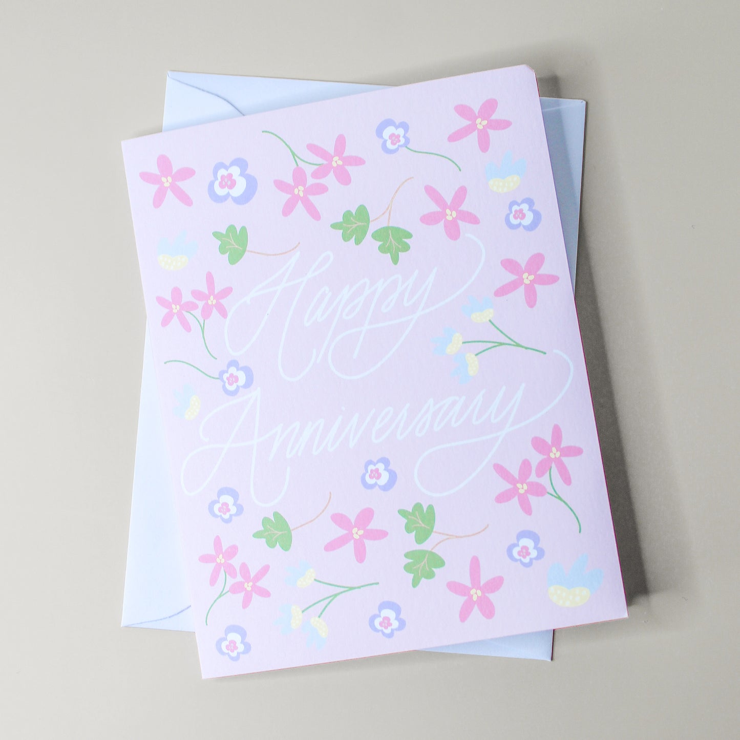 Our "Happy Anniversary" greeting card is too cute! Each card is folded to 4.25" tall by 5.5" wide, is blank inside and comes with a matching white envelope. Cards are packaged in cellophane sleeves.