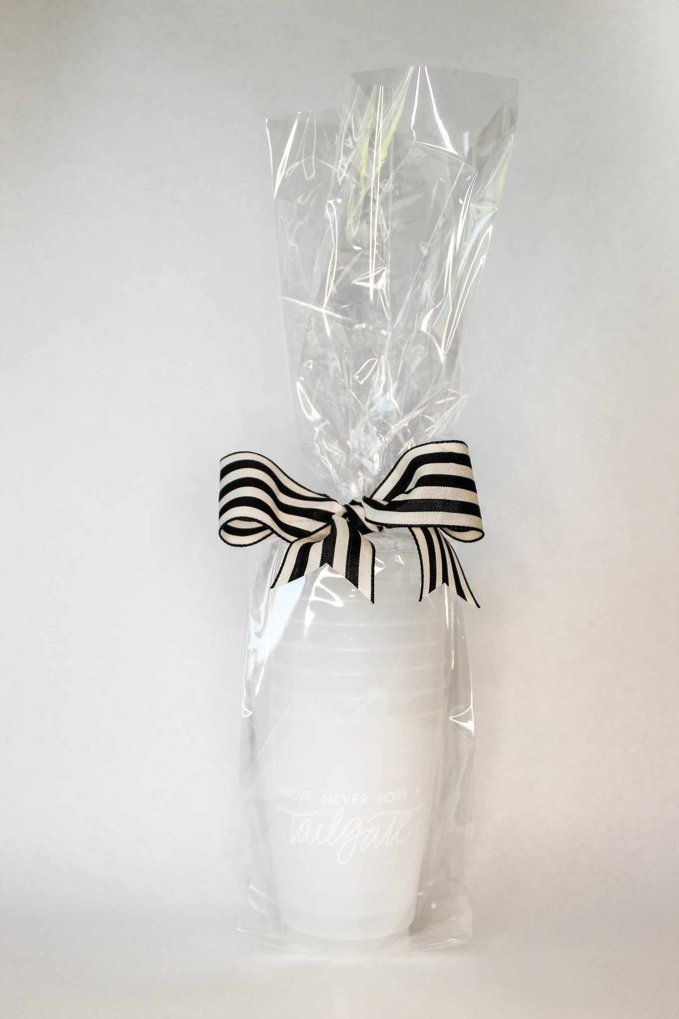 white We've Never Lost a Tailgate' cup, Tailgate party cup, Football party cup