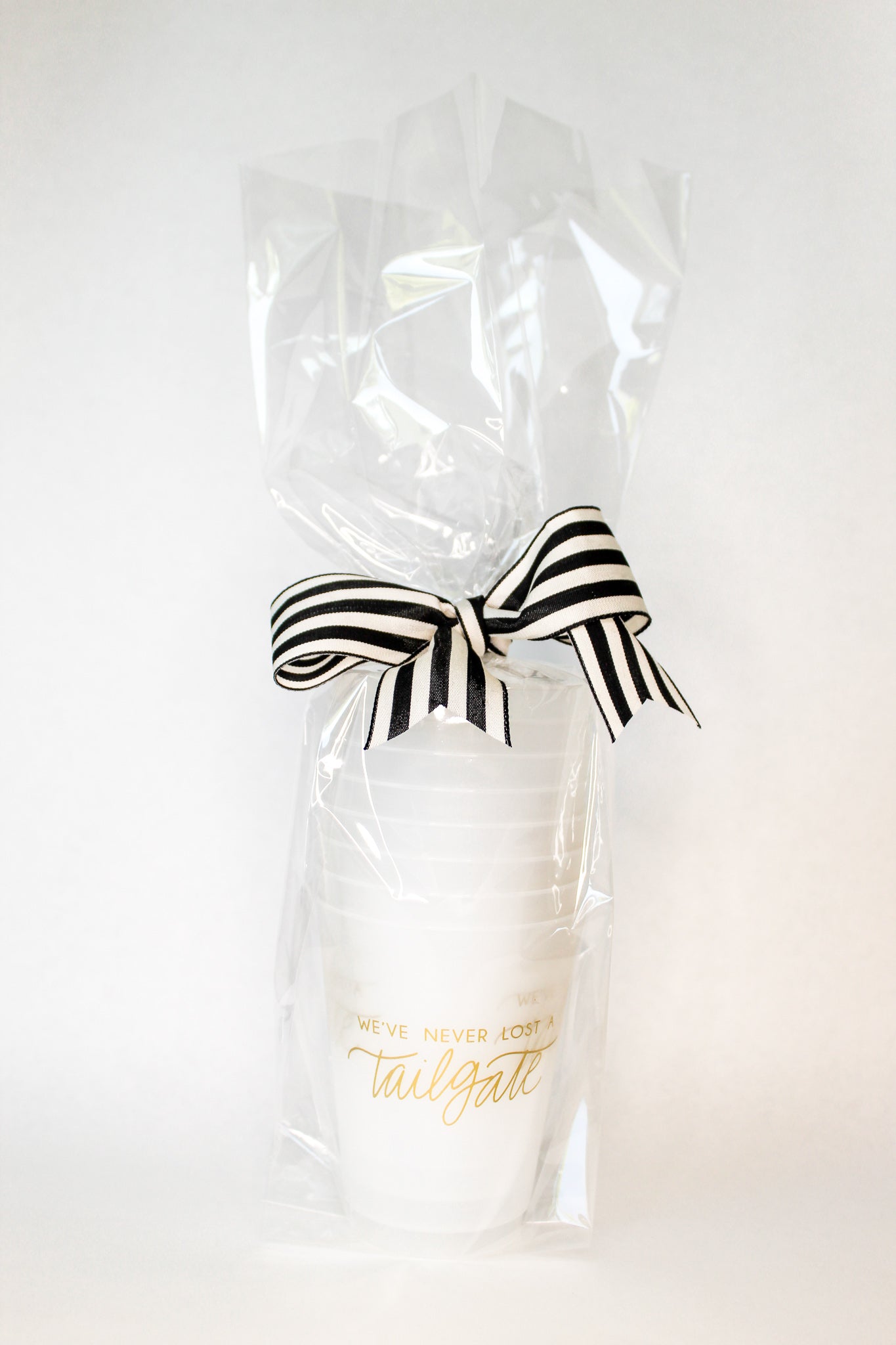 Gold We've Never Lost a Tailgate' cup, Tailgate party cup, Football party cup