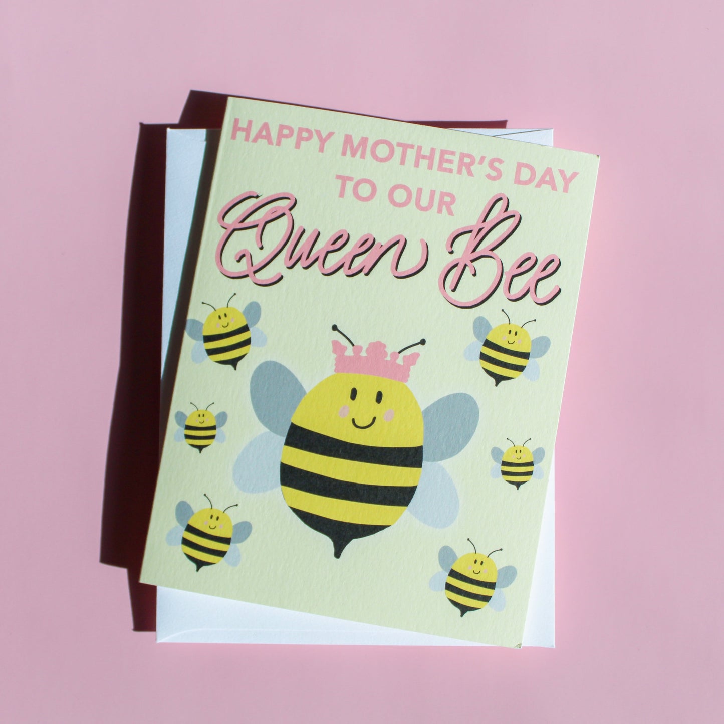 Our "Happy Mother's Day to our Queen Bee!" Mother's Day card features hand drawn queen bees on a yellow background - it is perfect for a mom, grandmother or any matriarch! Each card is folded to 4.25" tall by 5.5" wide, is blank inside and comes with a matching white envelope. Cards are packaged in cellophane sleeves.