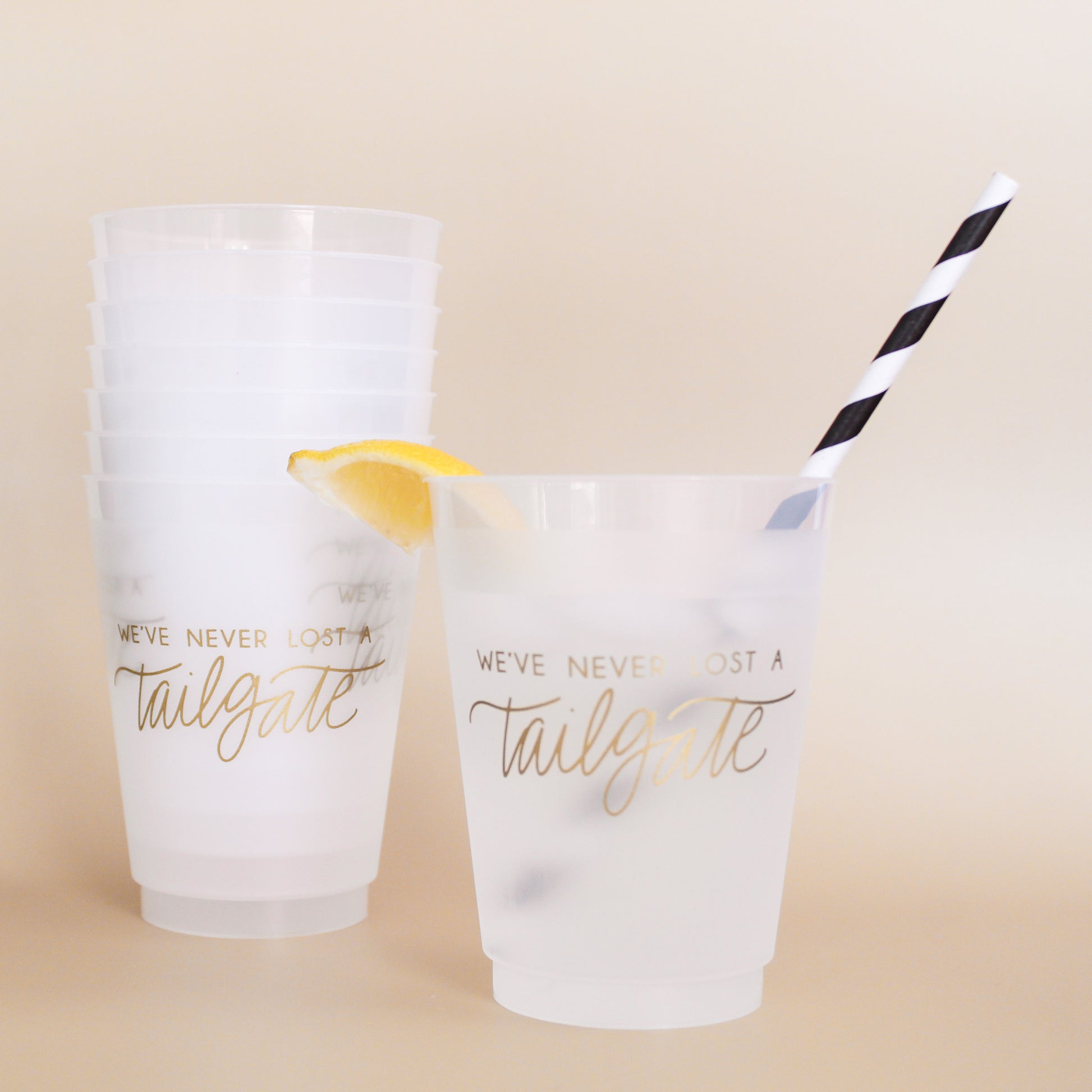Gold We've Never Lost a Tailgate' cup, Tailgate party cup, Football party cup