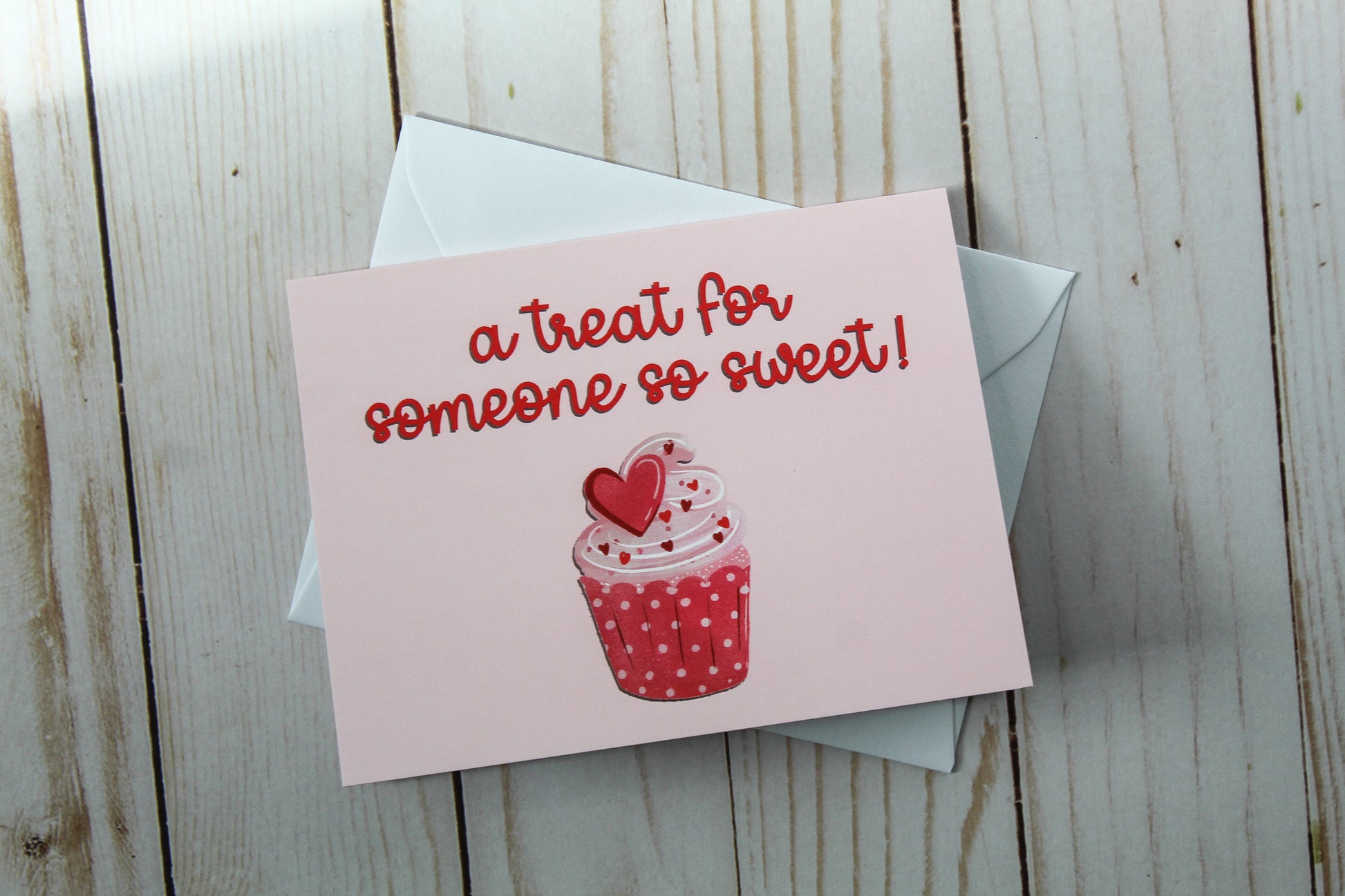 A Treat For Someone So Sweet' card showcases an adorable cupcake design set against a lovely pink background. These cards are meticulously folded to a size of 4.25" in height by 5.5" in width, offering a blank interior, greeting card