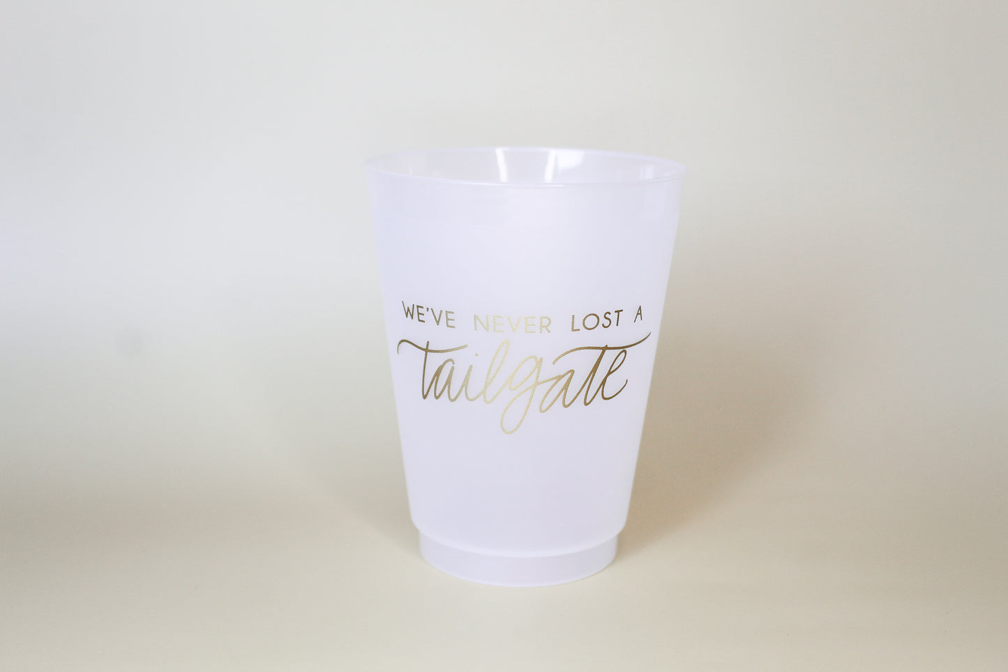 Gold We've Never Lost a Tailgate' cup, Tailgate party cup, Football party cup
