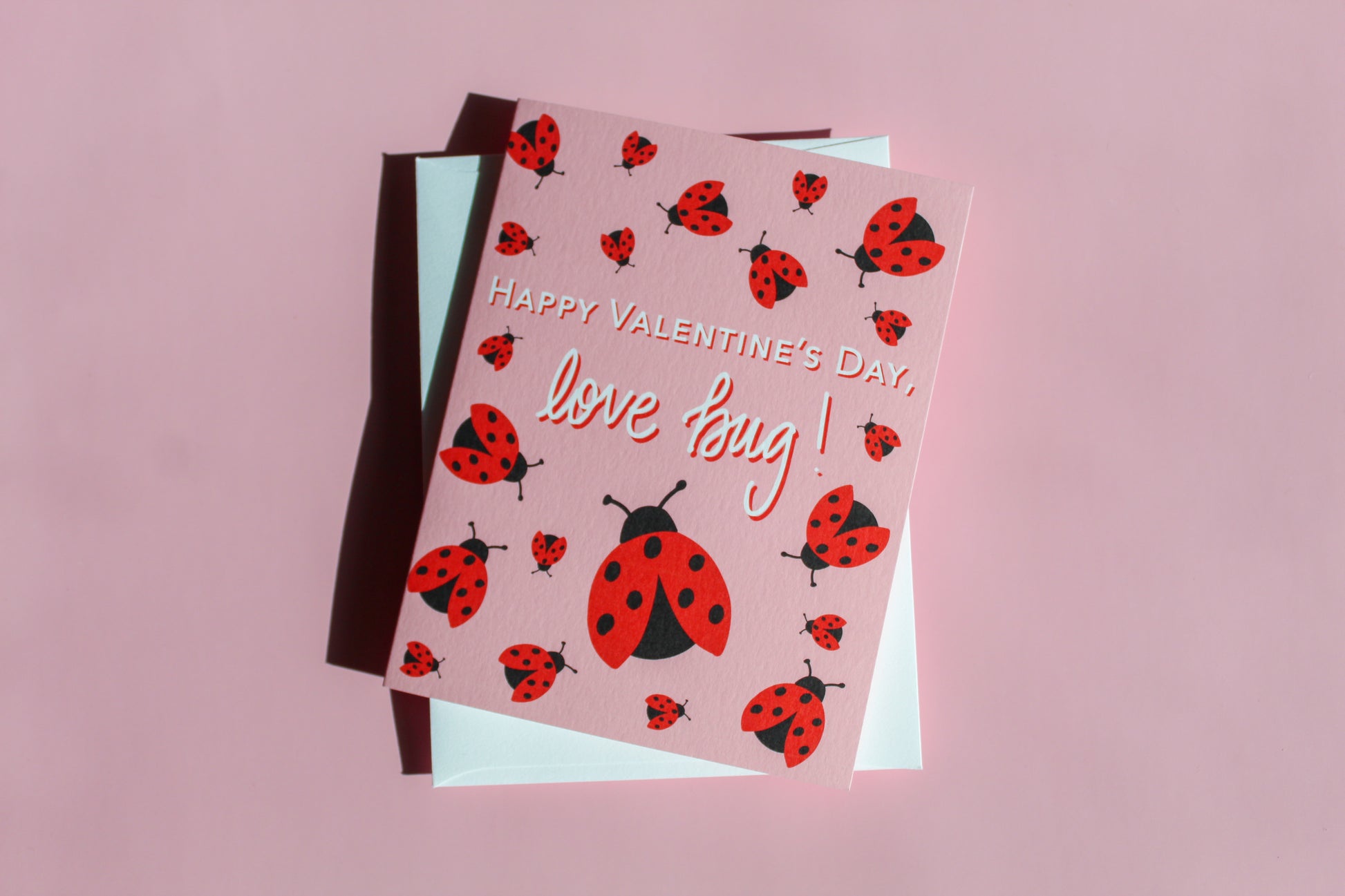 Our "Happy Valentine's Day, Love Bug!" Valentine's Day card features hand drawn lady bugs on a pink background - it is perfect for a kid or adult! Each card is folded to 4.25" tall by 5.5" wide, is blank inside and comes with a matching white envelope. Cards are packaged in cellophane sleeves.